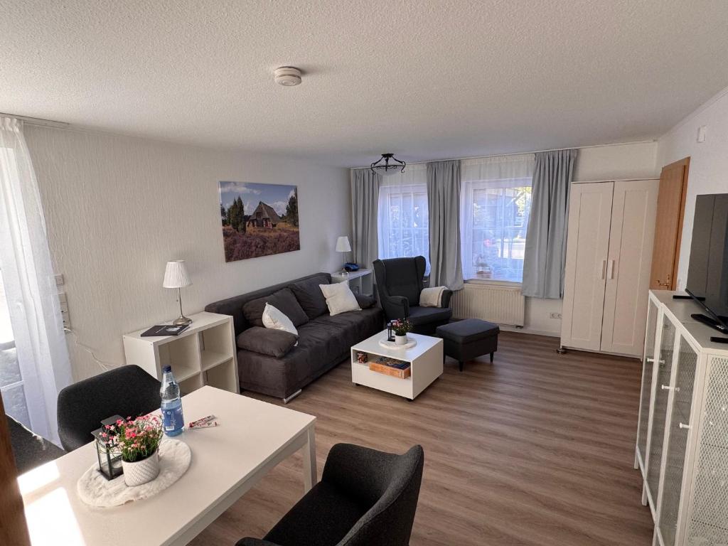 a living room with a couch and a table at Heideglück in Visselhövede