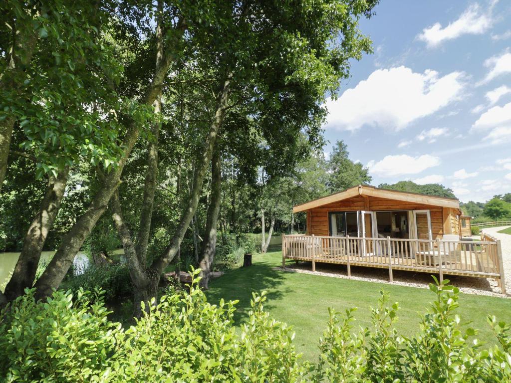 a cabin in a field with trees and grass at Skylark in Ross on Wye