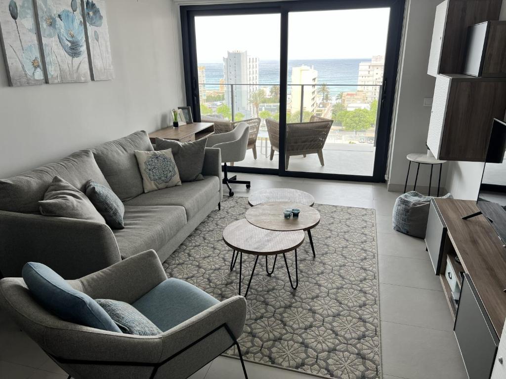 a living room with a couch and chairs and a table at Apartment-de-la-luz-calpe in Calpe