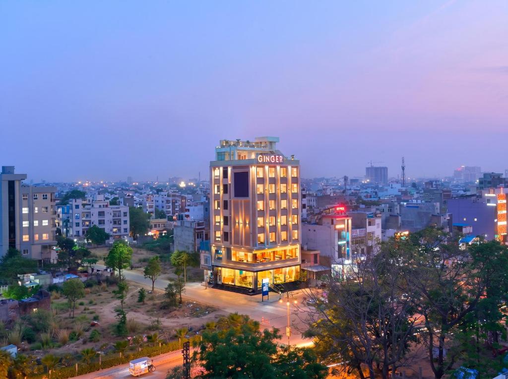 a lit up building in a city at night at Ginger Kota, Vishwakarma Nagar in Kota