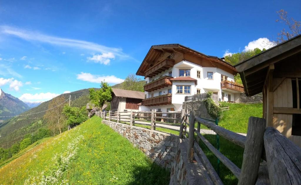 a house on a hill with a fence at Lechnerhof in Plaus