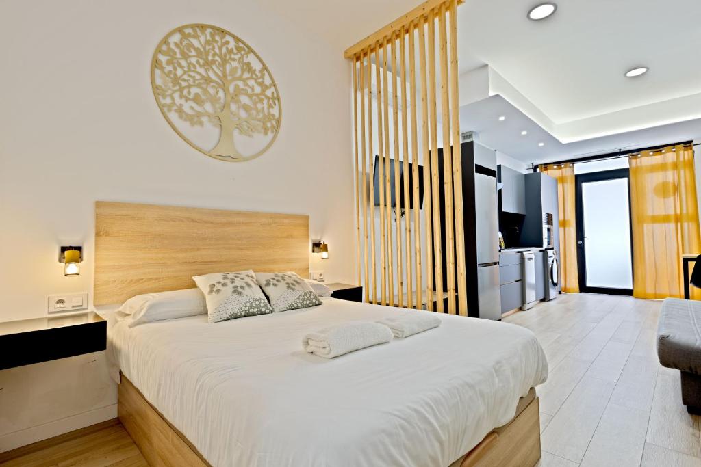 a bedroom with a large bed with white sheets at Apartamento Río Turia A in Valencia