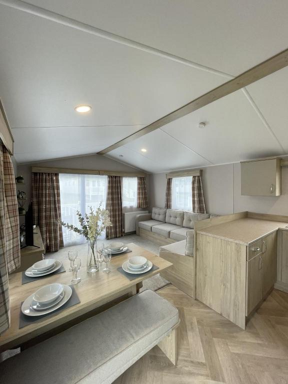 a living room with a table and a couch at Modern Seton Sands Caravan - sleeps 6 in Port Seton