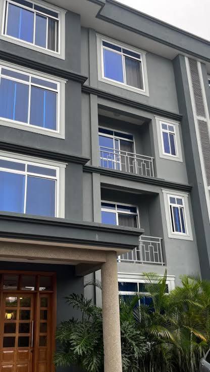 a large building with windows and a door at Kika resort hotel in Arusha