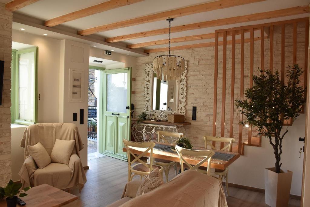 a kitchen and dining room with a table and chairs at Pelagio Residence in Samothraki