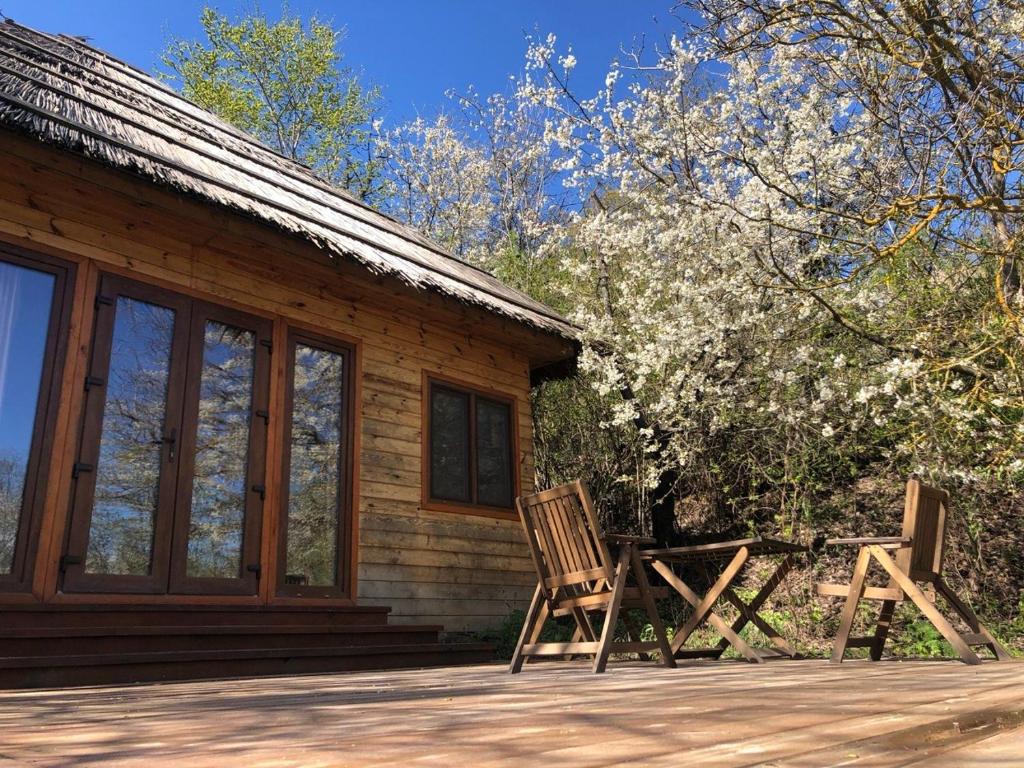 two chairs sitting on the porch of a cabin at Козацька Фортеця in Pliskachevka