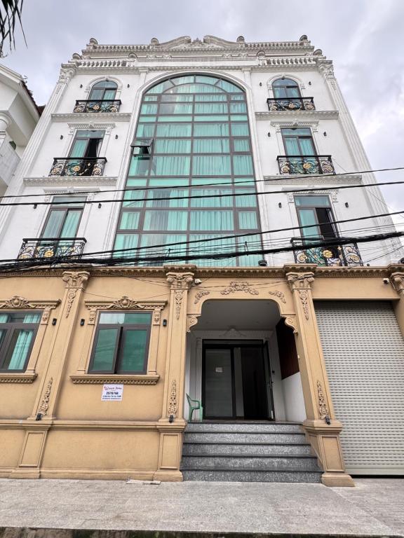 a tall building with stairs in front of it at Ngôi Nhà Mơ Ước in Ho Chi Minh City