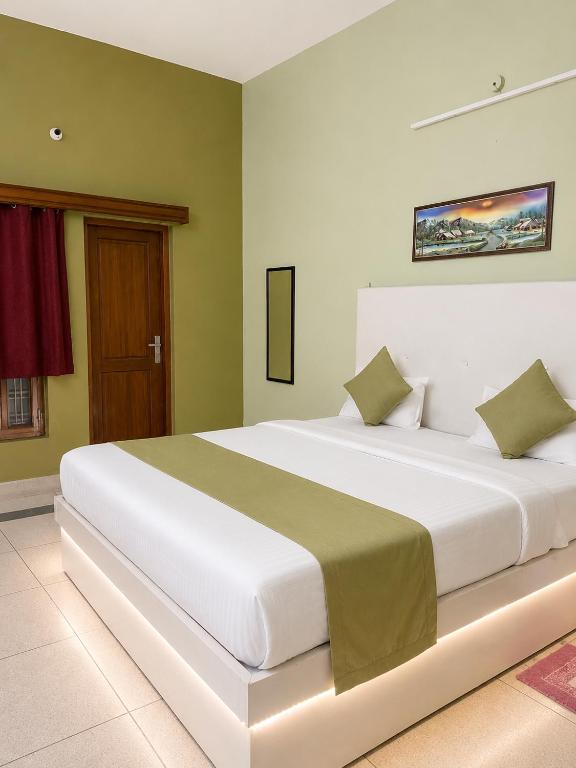 a bedroom with a large white bed in a room at Royal Inn in Lucknow