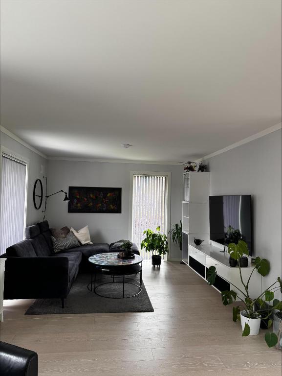 a living room with a couch and a table at Apartment close to Leknes airport in Leknes
