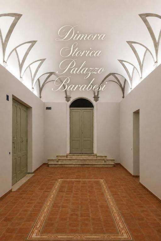 a large empty room with a sign on the ceiling at Dimora storica - Palazzo Barabesi in Siena