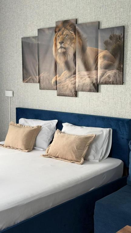 a lion sitting on a bed in a room at MEIMAN hotel in Aktobe