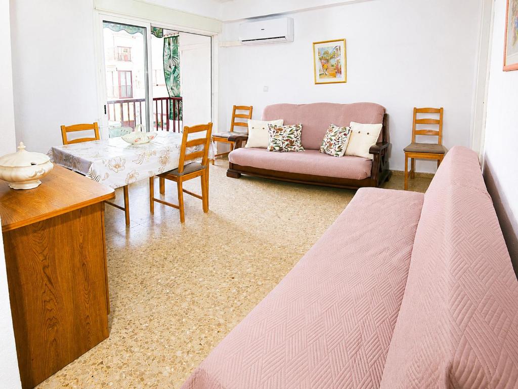 a living room with a bed and a couch at Vacansis Apartamento Cullera Mar in Cullera