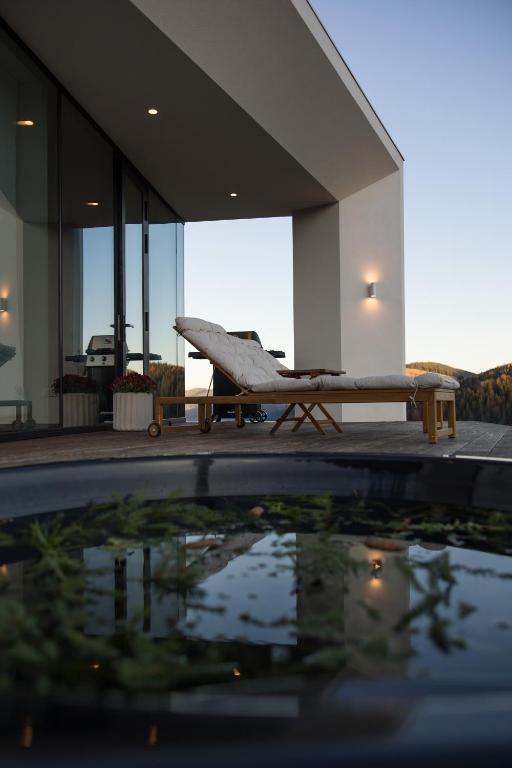 a view of a swimming pool with a bench in a building at Vershky Villas Верховина in Verkhovyna