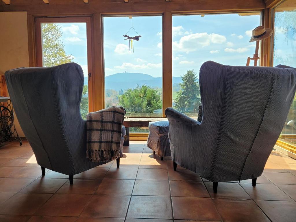 two chairs sitting in a room with a large window at Ferienhaus Rasselbock in Waltershausen