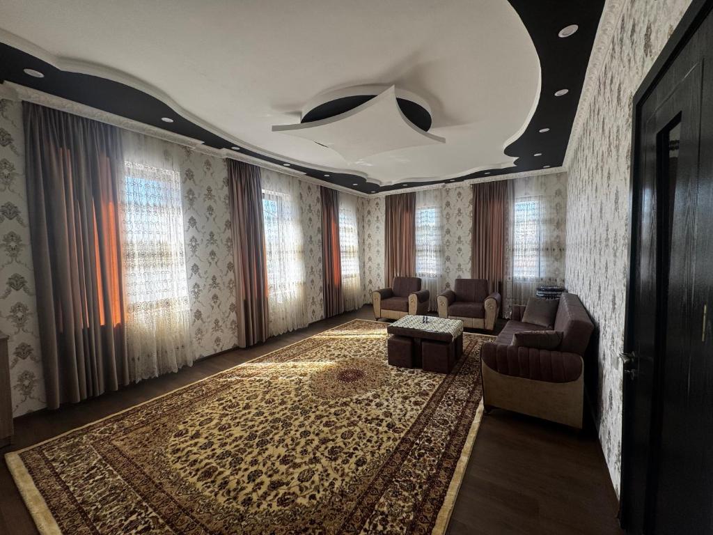 a living room with a couch and chairs and windows at Terrasa Solar Kutaisi in Kutaisi