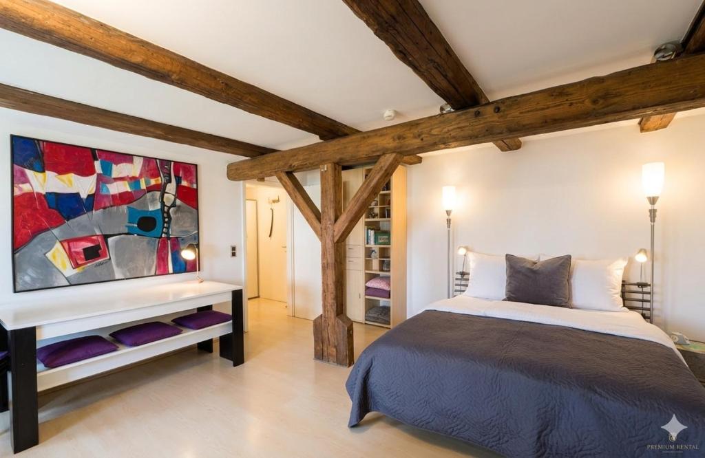a bedroom with a bed and a painting on the wall at Apartment Regensburg in Regensburg