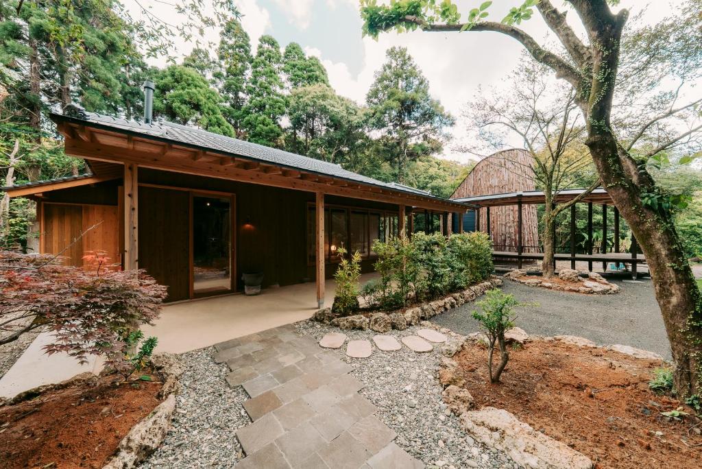 an exterior view of a house with a tree at inishie in Nishinoomote