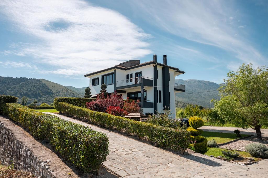 a house with a hedge in front of it at Gaia Villa in Thesprotikón