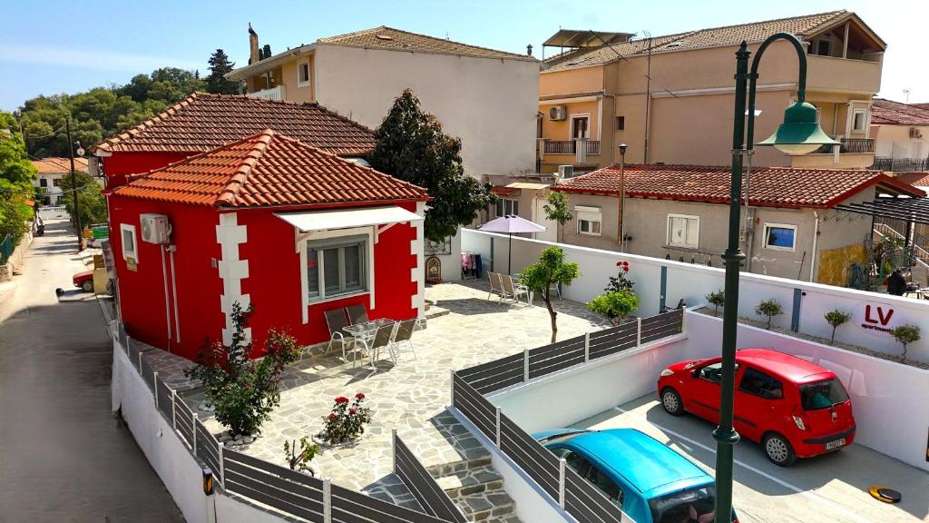 a red house on the side of a street at LV Luxury Apartment in Parga