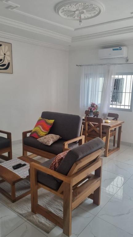 a living room with a couch and a table at Résidence PAYAN in Douala