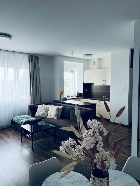 a living room with a couch and a table at Apartament Atrium Sarbinowo in Sarbinowo