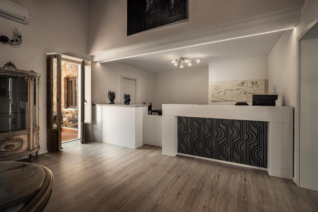 a large living room with a counter and a table at Viscuso House B&B in Aci Castello