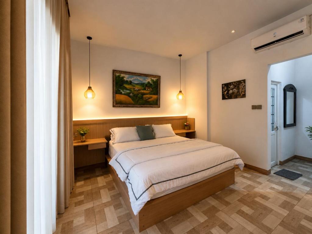a bedroom with a large bed in a room at Holi Saren Guest House in Nusa Dua