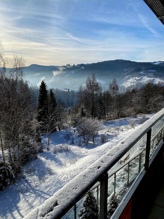 a view from a balcony of a snow covered mountain at Apartment Mountain Panorama in Wisła