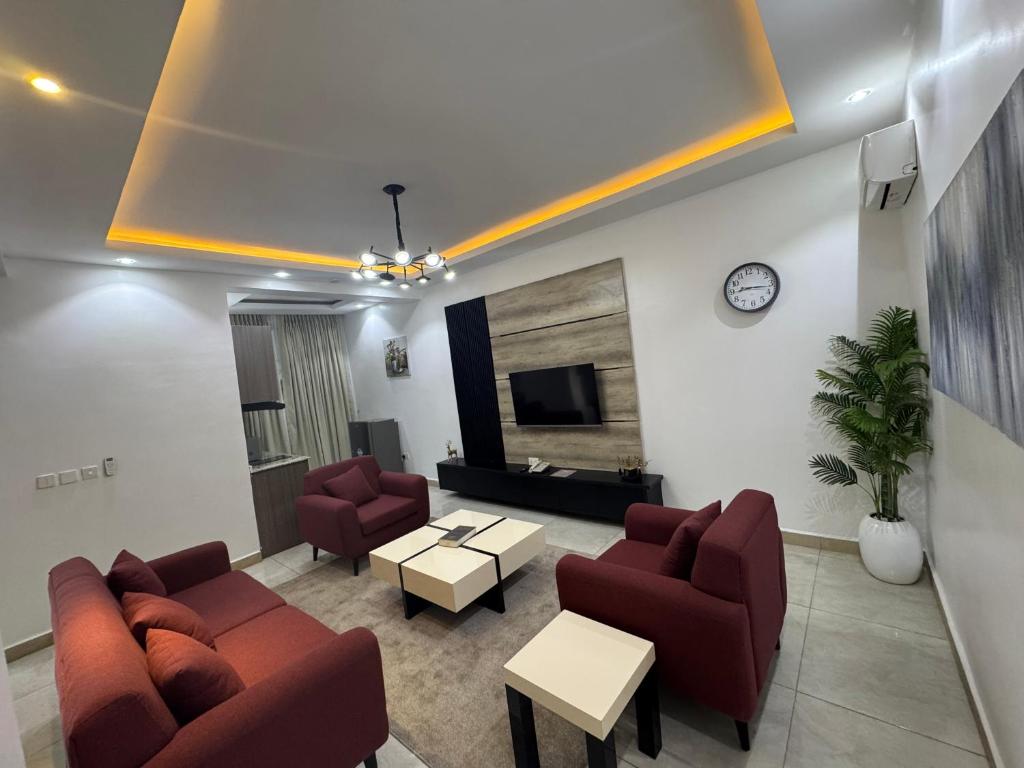 a living room with two couches and a tv at Garden Ridge in Abuja