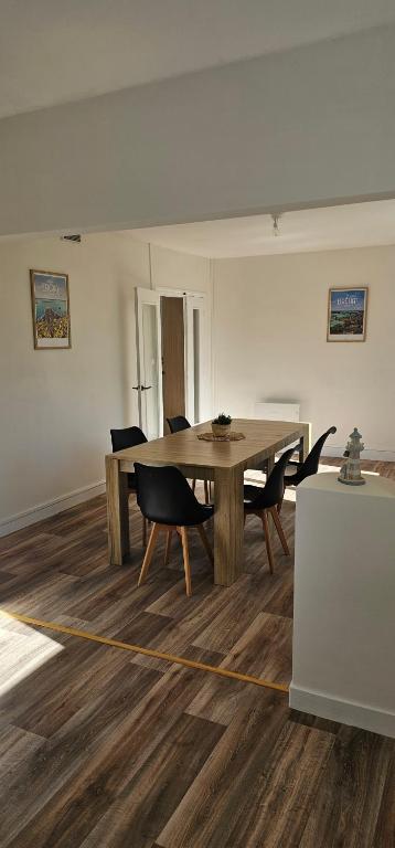 a dining room with a wooden table and chairs at Appartement T4 proche gare in Guingamp