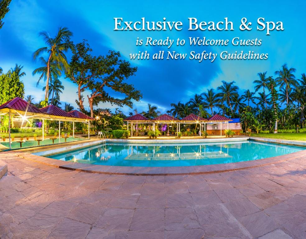 a resort with a swimming pool and a spa with palm trees at Toshali Sands Puri in Puri