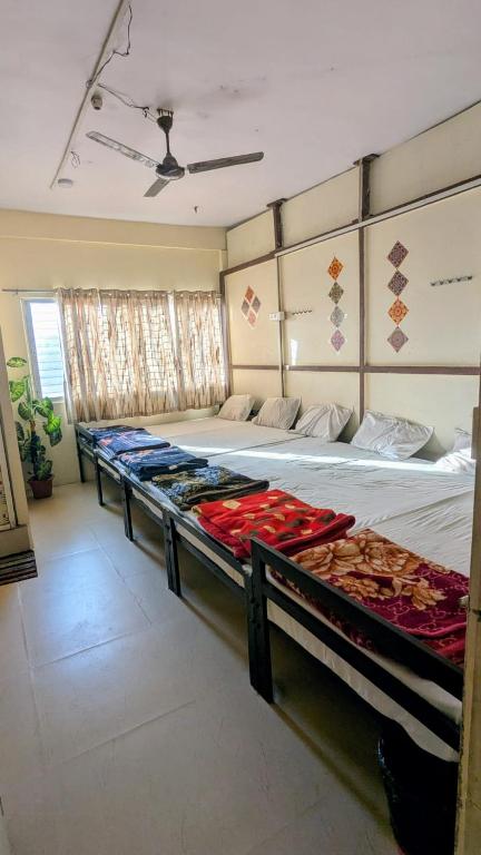 two beds in a room with at KSHIPRA GUEST HOUSE in Ujjain