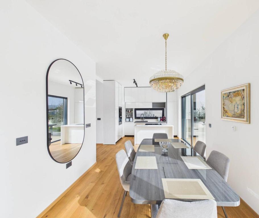 a dining room with a table and a mirror at Vila Volme in Banjole