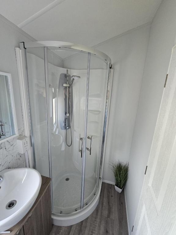 a glass shower in a bathroom with a sink at Bwr27 in East Mersea