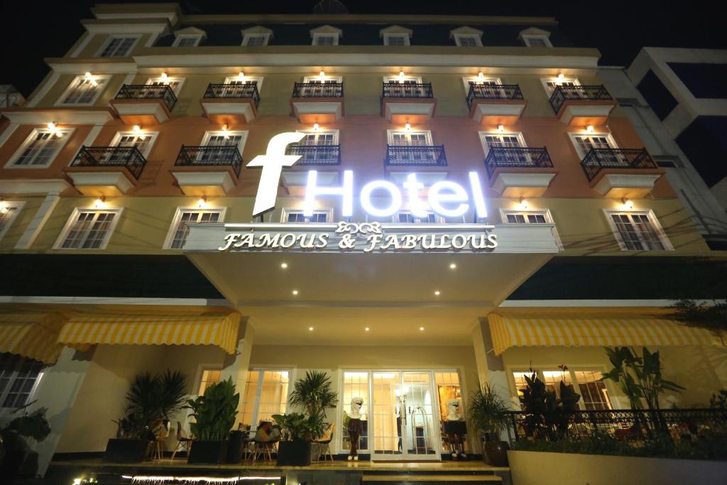 a hotel with a neon sign on the front of it at F Hotel Jakarta in Jakarta