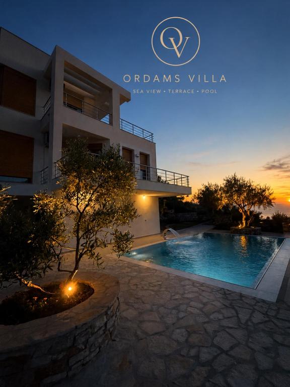 a villa with a swimming pool at dusk at ORDAMS Villa in Himare