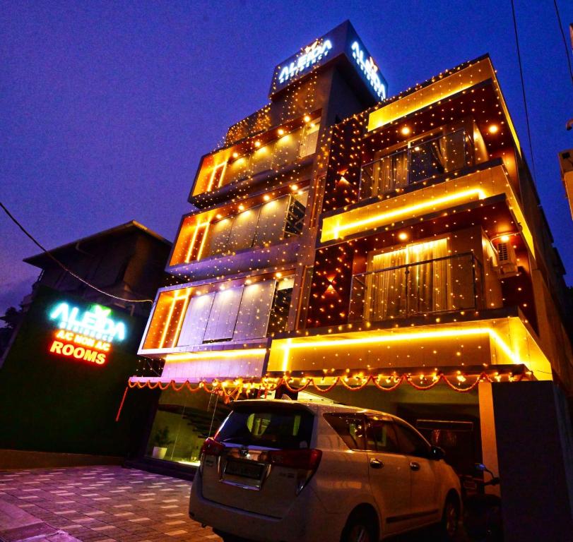 a building with a car parked in front of it at Aleida Residency in Cochin