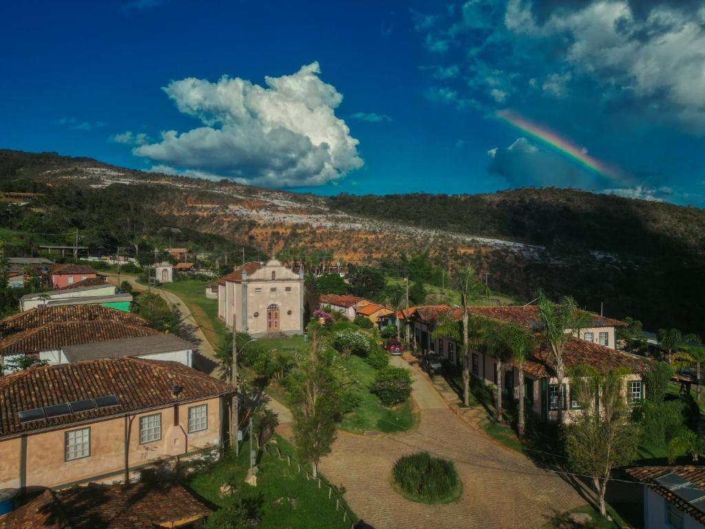 an aerial view of a town with a rainbow in the sky at Ibiti Village in Lima Duarte