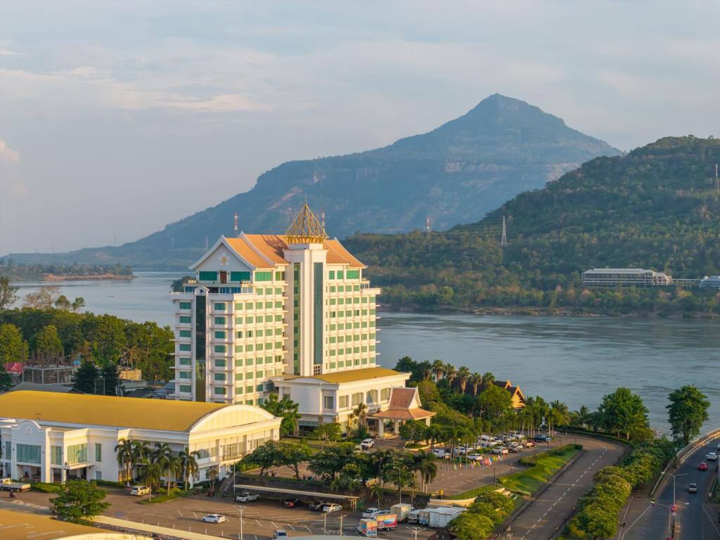 a large building next to a body of water at Champasak Grand Hotel in Pakse