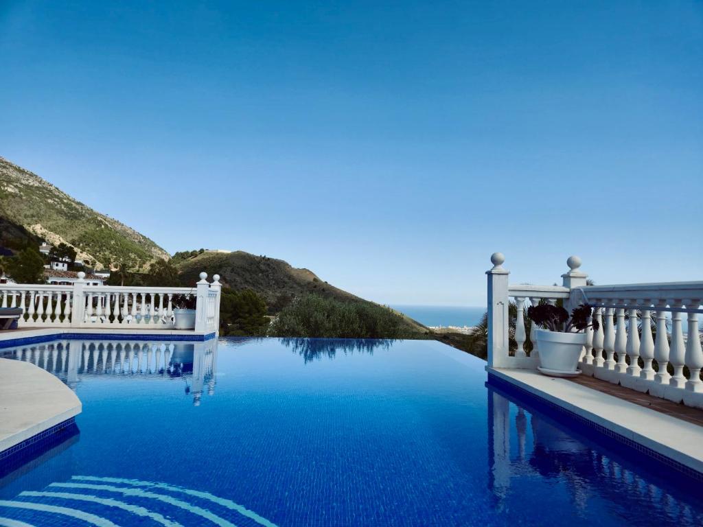 a swimming pool with a view of the ocean at Villa Mañana in Mijas
