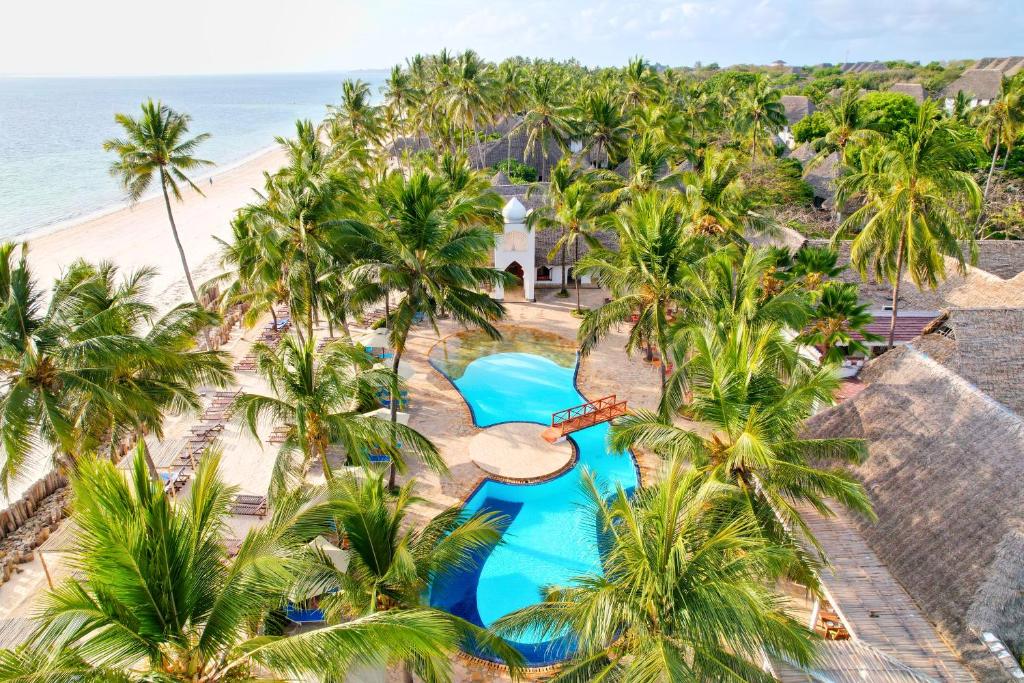 an aerial view of a resort with a pool and palm trees at Sultan Sands Island Resort & Spa in Kiwengwa