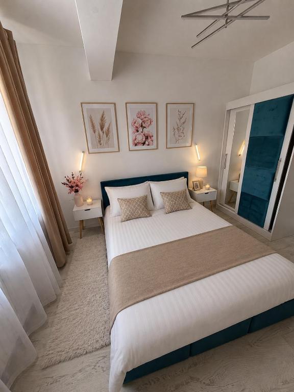 a bedroom with a large bed and a window at Noblesse residence - parking Militari residence Chiajna Dudu in Chiajna