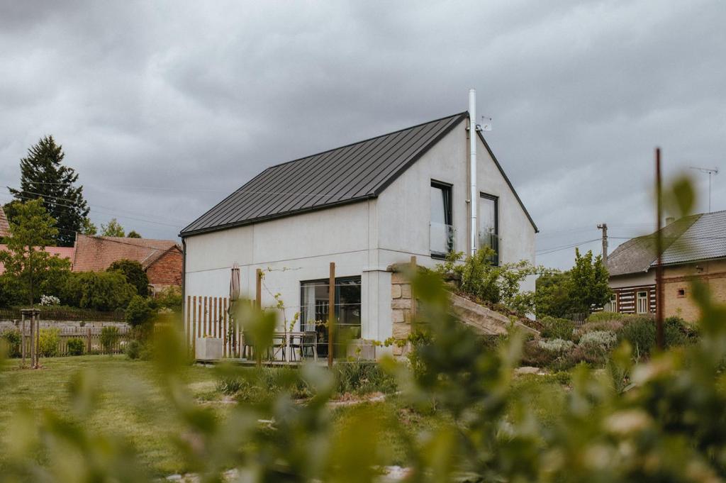 a white barn with a black roof at Druhej Domek u ráje in Bystřice
