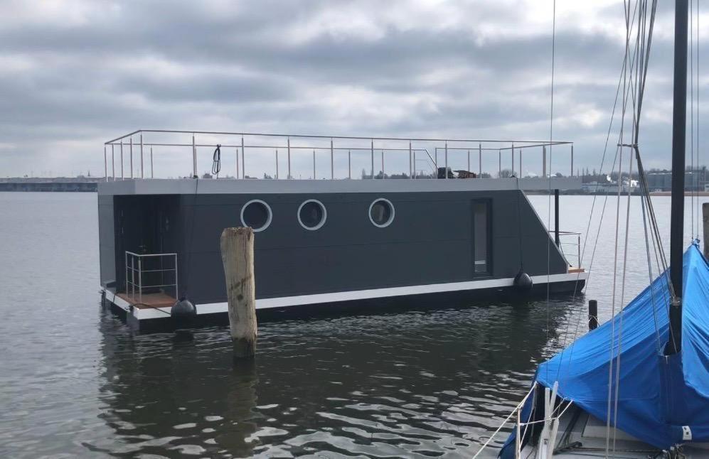 a boat is docked at a dock in the water at AURORA in Lübeck