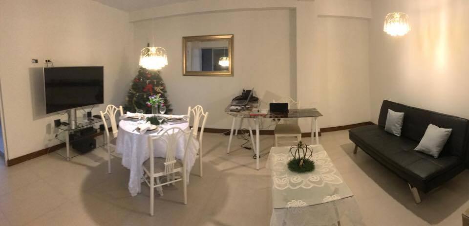 a living room with a table and a christmas tree at Edificio California en Centro Historico in Lima