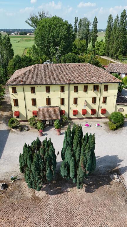 an aerial view of a building with trees in front at Hotel Antico Casale in Vigarano Mainarda