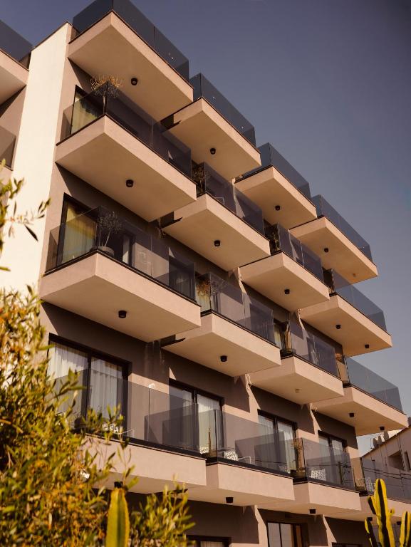 a tall apartment building with balconies on it at Foga Aus in Ksamil