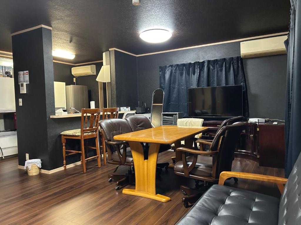 a room with a table and chairs and a television at Hamachidesu - Vacation STAY 15817 in Akiruno