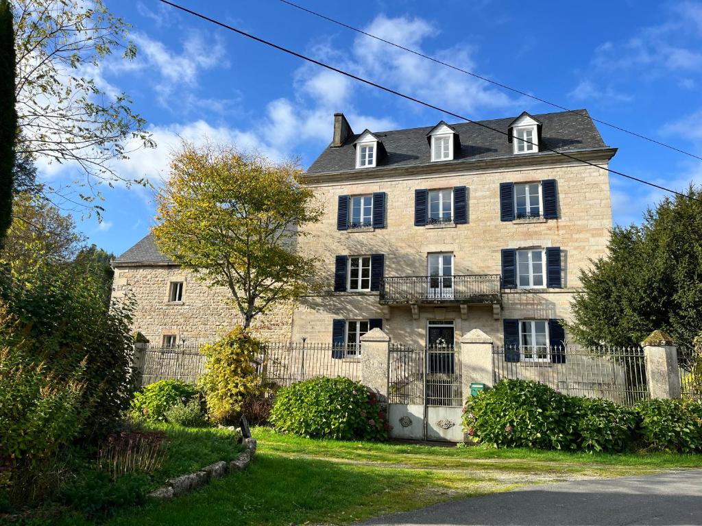 a large stone house with a black roof at Chez Jallot - Lower Gite in Vidaillat