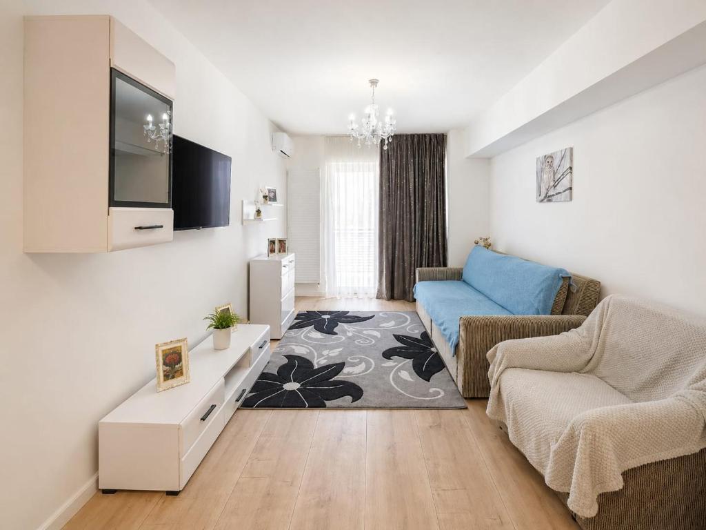 a living room with a couch and a tv at Abel 24 Residence in Bacău